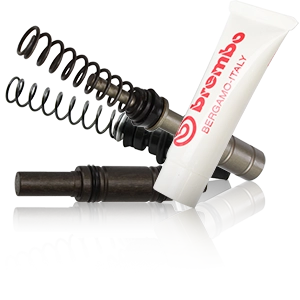 Kit de reparación para cilindros de freno Brembo con pistones, resortes y pasta de montaje.